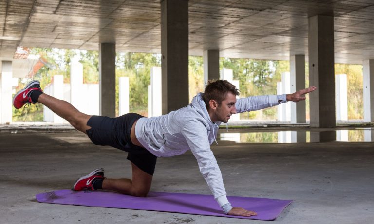 man-stretching-downward-dog-position-back-pain